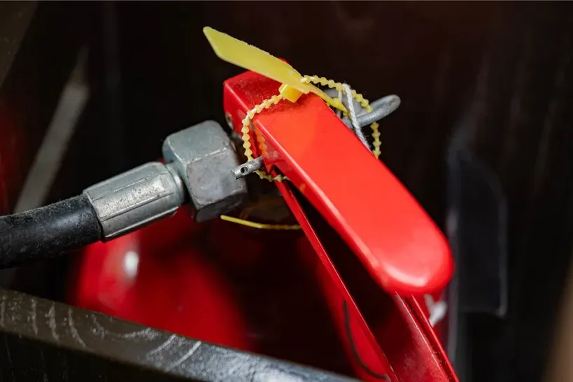 An example of a plastic pull-tight seal around a fire extinguisher